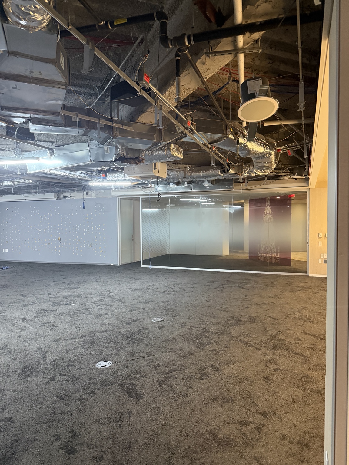 Open commercial interior with glass partitions from an actual project